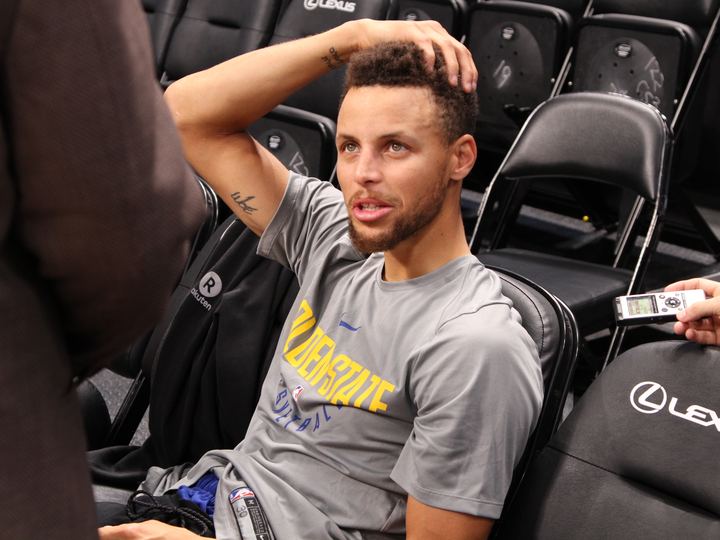 Stephen Curry speaking to reporters